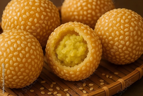 Traditional Indonesian onde-onde, deep-fried golden sesame seed ball with sweet mung bean paste filling, popular Asian snack and street food.