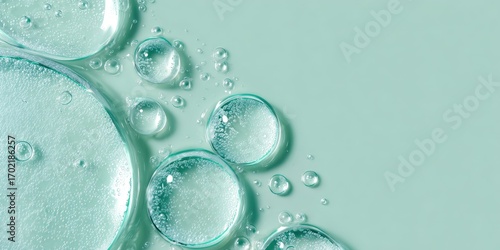 Mint-green backdrop with clear liquid droplets