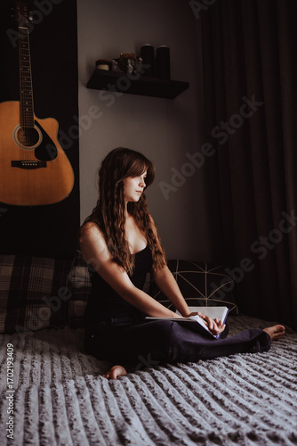 girl with a guitar in the room