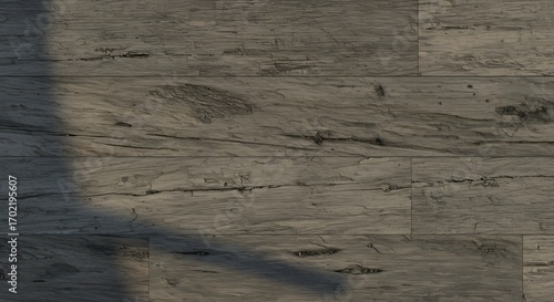 Wooden floorboards in various shades of gray Shadow falls across some boards
