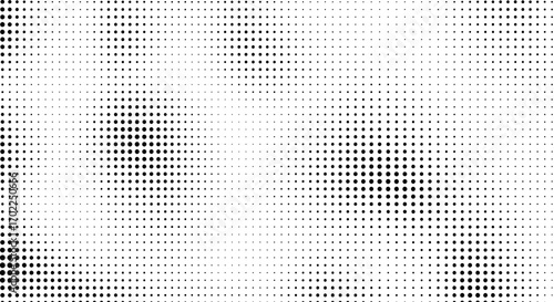 Abstract halftone pattern with varying density of black dots fading into a white background, creating a textured effect.