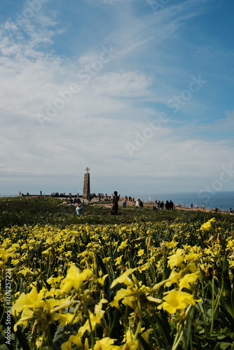 Scenic landscape of Cabo da Roca lighthouse with blue sky dramatic cliffs Atlantic Ocean rugged coastline in Sintra Portugal popular travel destination viewpoint with natural vegetation. High quality