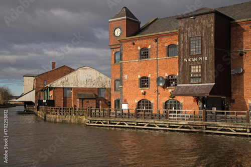 Принти на полотні Restored warehouses alongside the Leeds Liverpool canal at Wigan Pier now converted to restaurants and night clubs