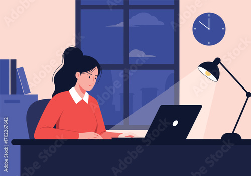 A young woman working late at night on her laptop with a desk lamp providing focused illumination on her workspace