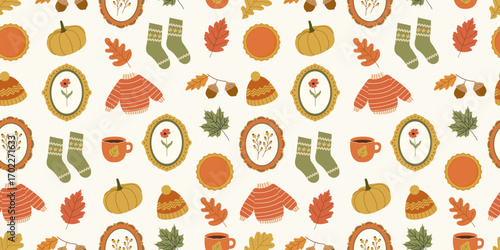 Autumn cozy seamless pattern. Cute fall season design with hand drawn pumpkins, sweaters, socks, pie, coffee mug, beanie hat, frames with flowers, acorns. Vector background for wrapping paper, fabric.