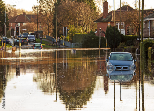 A flooded road junction with a drowned car