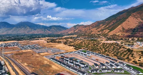 Spanish Fork city in the Utah Valley, Utah, USA. Dramatic clouds hang over the mountains at backdrop.