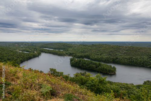 Panoramic view from Elliot Lake's fire tower, overlooking lush forests and the distant horizon under an overcast sky.