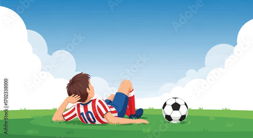 Young Athlete Reclining On Green Field Next To Soccer Ball Enjoying The Fresh Air