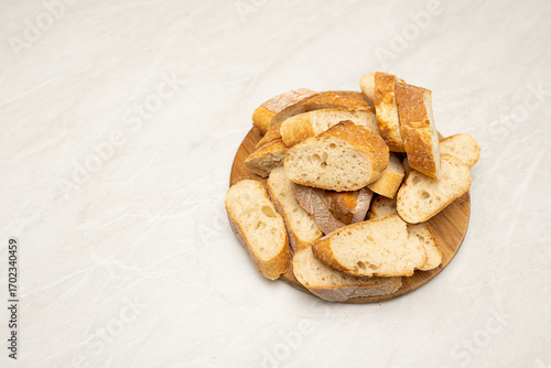 Top View of Sliced French Bread on Wooden Cutting Board with Copy Space