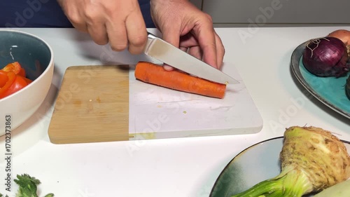 Cut the carrot into smaller pieces with a knife.