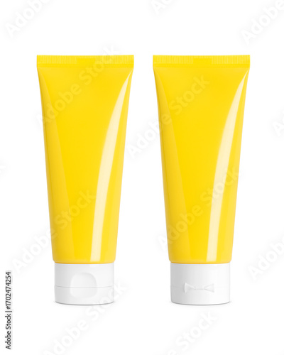 Yellow plastic cosmetic tubes with white flip caps, front and back view on transparent background, clean packaging mockup