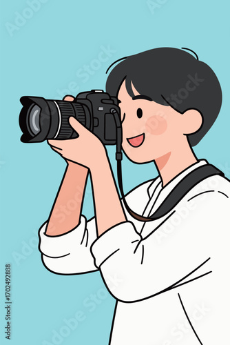 A happy young man with a camera to his eye, smiling while looking through the viewfinder to take a photo, representing photography, hobbies, and a passion for travel or creativity.
