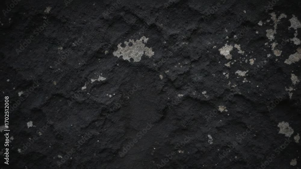 Hand touching dark rock surface