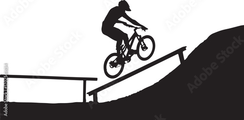 Silhouette of a mountain biker riding down a ramp on a dirt track with obstacles mountain biking bicycle