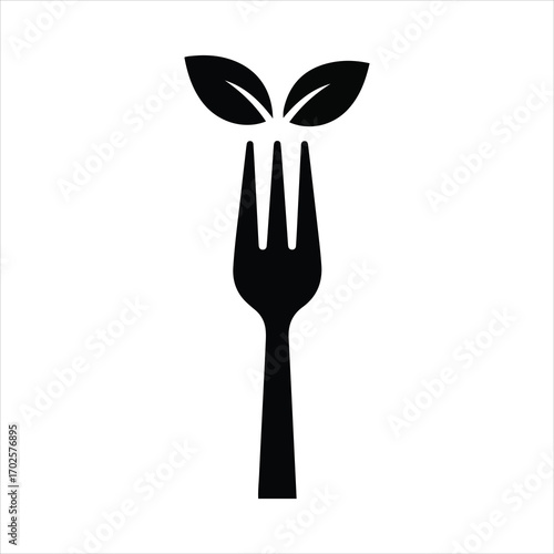 Organic food concept fork with green leaves symbolizing healthy natural cuisine and nutrition