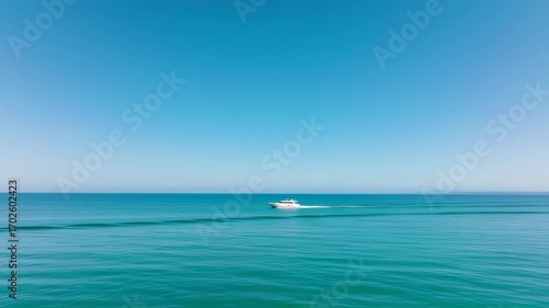 Calm sea, bright sky, lone boat
