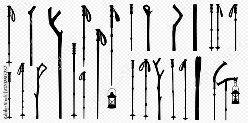 A diverse collection of black silhouette walking sticks, hiking poles, and staffs, including natural designs and two with hanging lanterns.
