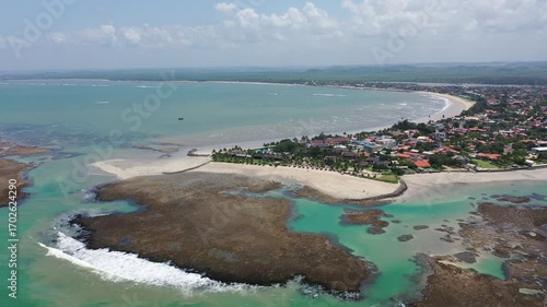 Fantastic panoramic view of Serrambi beach with coral reefs, natural swimming pools in the sea, white sand and palm trees. Serrambi near Recife in Pernambuco State, Brazil 