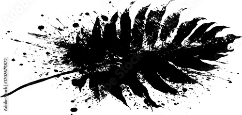 Black ink grunge silhouette of palm leaf with splatter effect for creative design