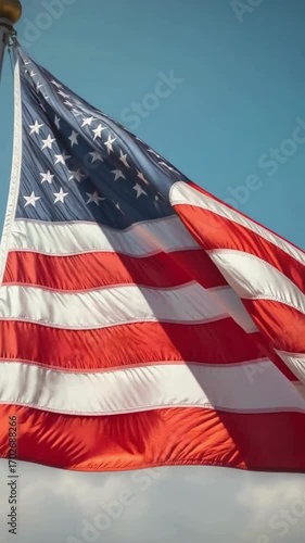 American Flag Waving in the Blue Sky with Clouds