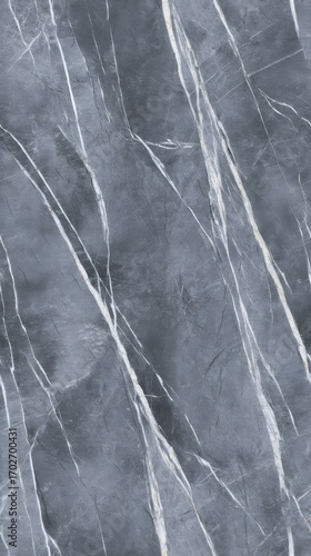 A textured surface of grey marble with irregular white and light grey veins creates a natural and abstract pattern,