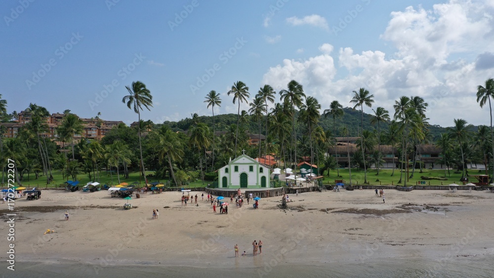 Fototapeta premium Wonderful aerial view of Praia dos Carneiros beach with an old church, stunning landscape with sand banks, palm trees, boats and turquoise waters near Recife, Pernambuco State, Brazil