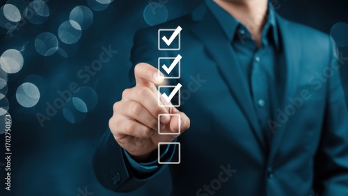 Wallpaper Mural Checklist of Success: A hand in a suit points to a checklist, with each box marked, against a backdrop of blurred lights. Suggesting focus and planning Torontodigital.ca