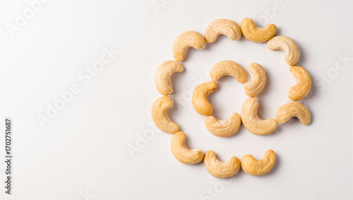 Cashews arranged creatively on a light background in playful spirals