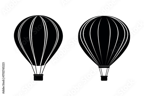 two hot air balloons floating in sky silhouette