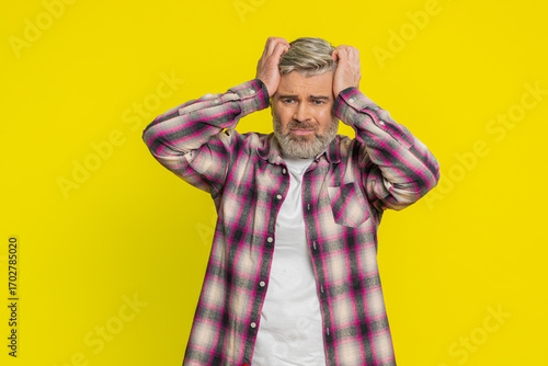 Photography Caucasian middle-aged man on yellow background showing powerless frustration, hopeless stress, depression