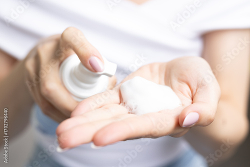 A woman using facial cleansing foam.