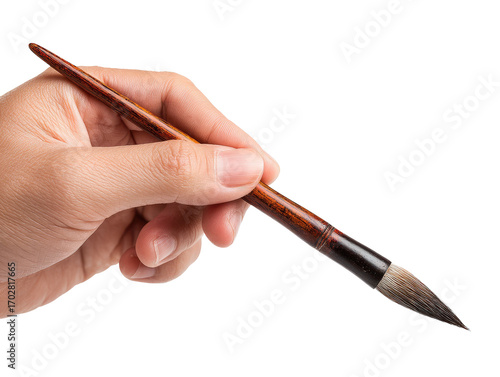 Close-up of hand holding a calligraphy brush