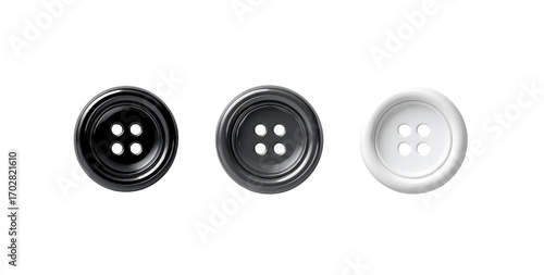 Three buttons, black, dark gray, and white, on a dark background. Each button has a smooth, rounded shape and four small holes