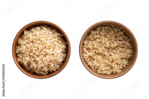 Two wooden bowls, each filled with cooked brown rice.  Top down view