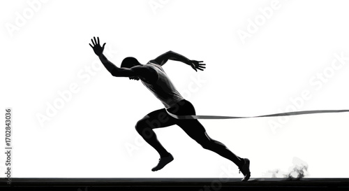 Silhouette of a focused male athlete sprinting, crossing the finish line with determination and