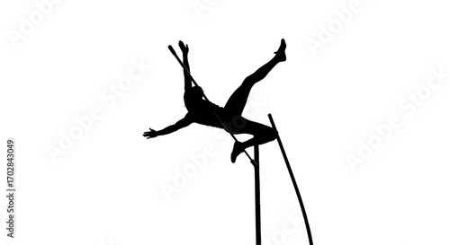 Silhouette of a pole vaulter soaring over the bar during intense athletic competition