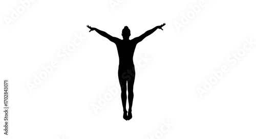 Silhouette of an acrobat dancer poised in mid air conveying freedom and liberation