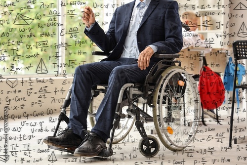 Male teacher in wheelchair ...