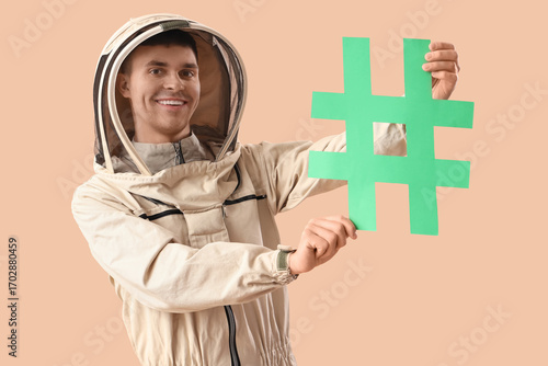 Male beekeeper in protectiv...