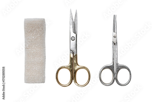 Medical kit items a beige gauze pad, gold-toned and silver-toned scissors