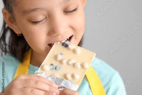 Cute little Asian girl eati...