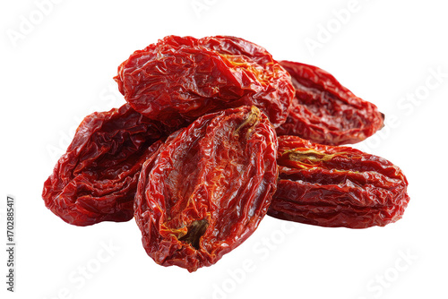 Pile of deep red, dried, oval-shaped fruits, close-up against black background