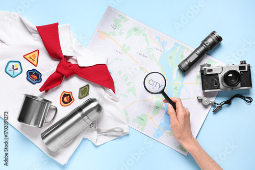 Hand with magnifier, map an...