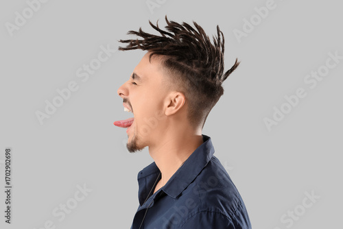 Young man with dreadlocks s...