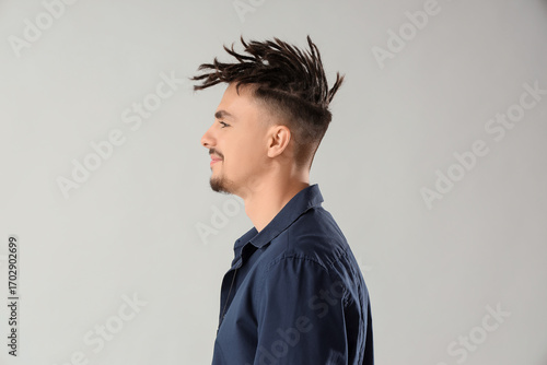 Young man with dreadlocks o...