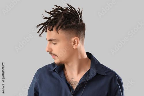 Young man with dreadlocks o...