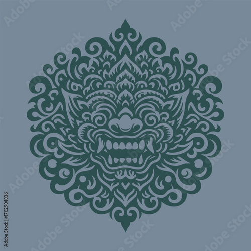 Intricate symmetrical tribal mask barong design with fierce expression and ornamental swirling patterns in dark green tones
