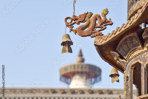 Dragon Ornament with Bell Hanging from Traditional Temple Roof