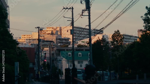 Cinematic Tokyo Urban Street View – Golden tones illuminating residential high-rises and wires.